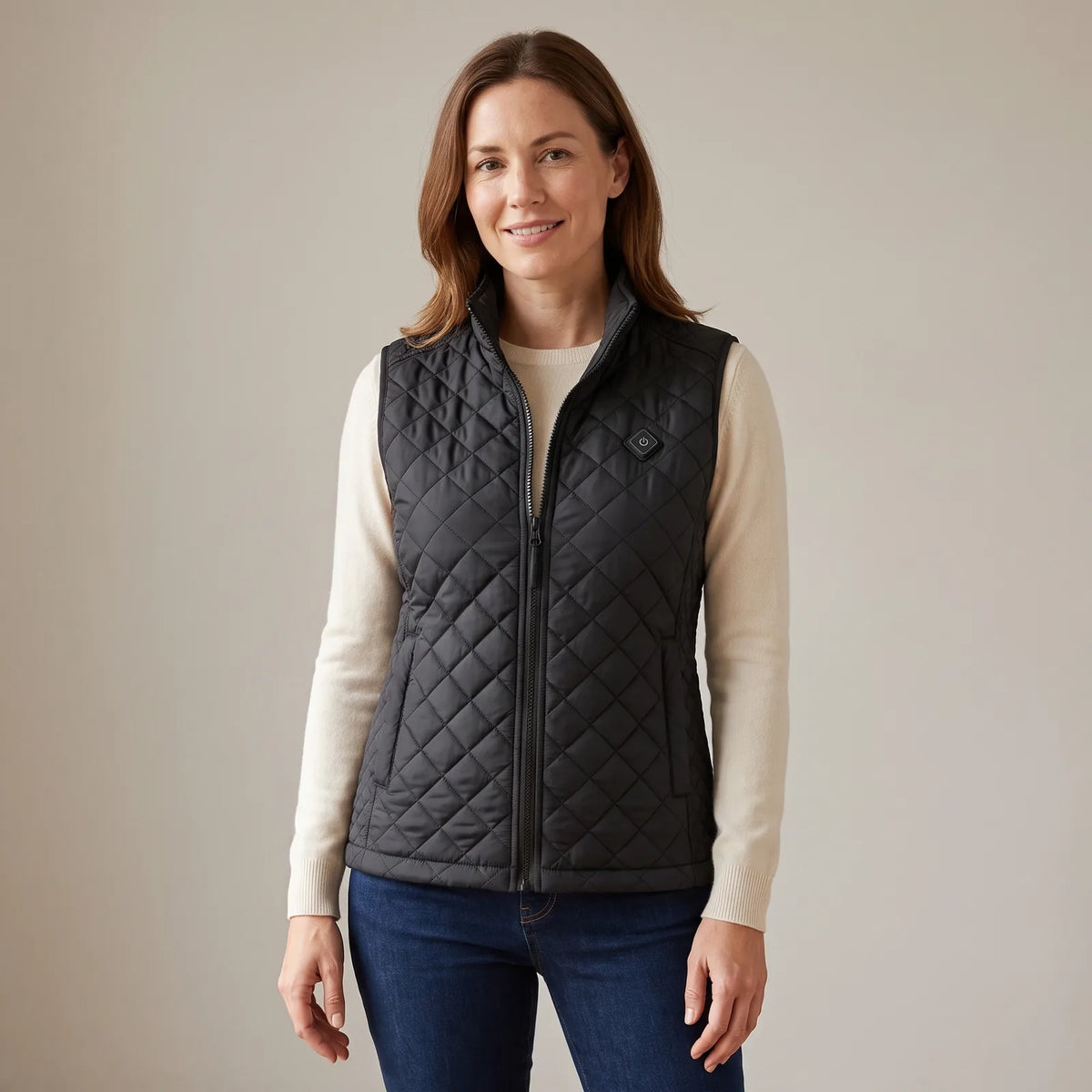Woman wearing the black heated vest over a light knit sweater
