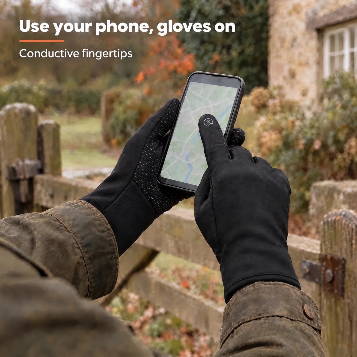 Hands in the Grip gloves using a smartphone at a garden gate